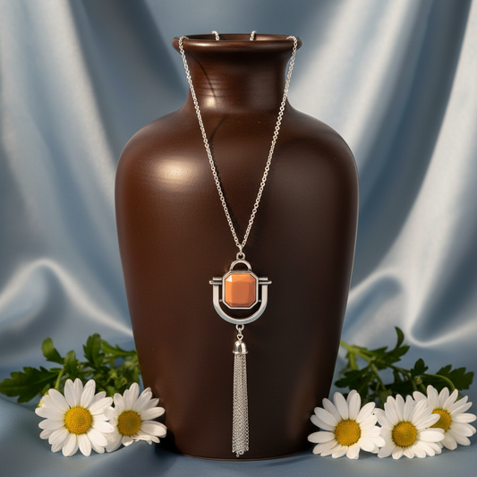 Funky Fringe Brown opera length necklace on dark brown ceramic vase with dusty blue silk backdrop and white daisies